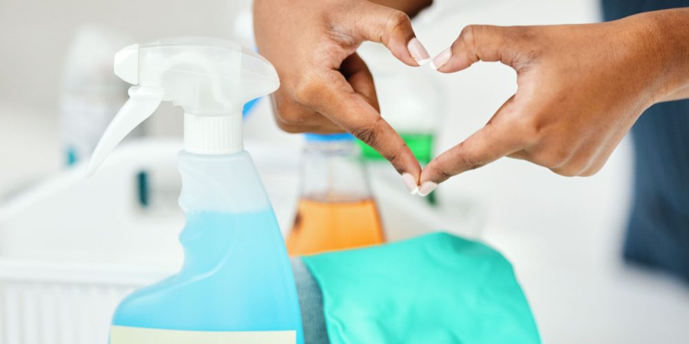 Heart hands, cleaner and chemical detergent bottle, cleaning kitchen and closeup of supplies for hy.